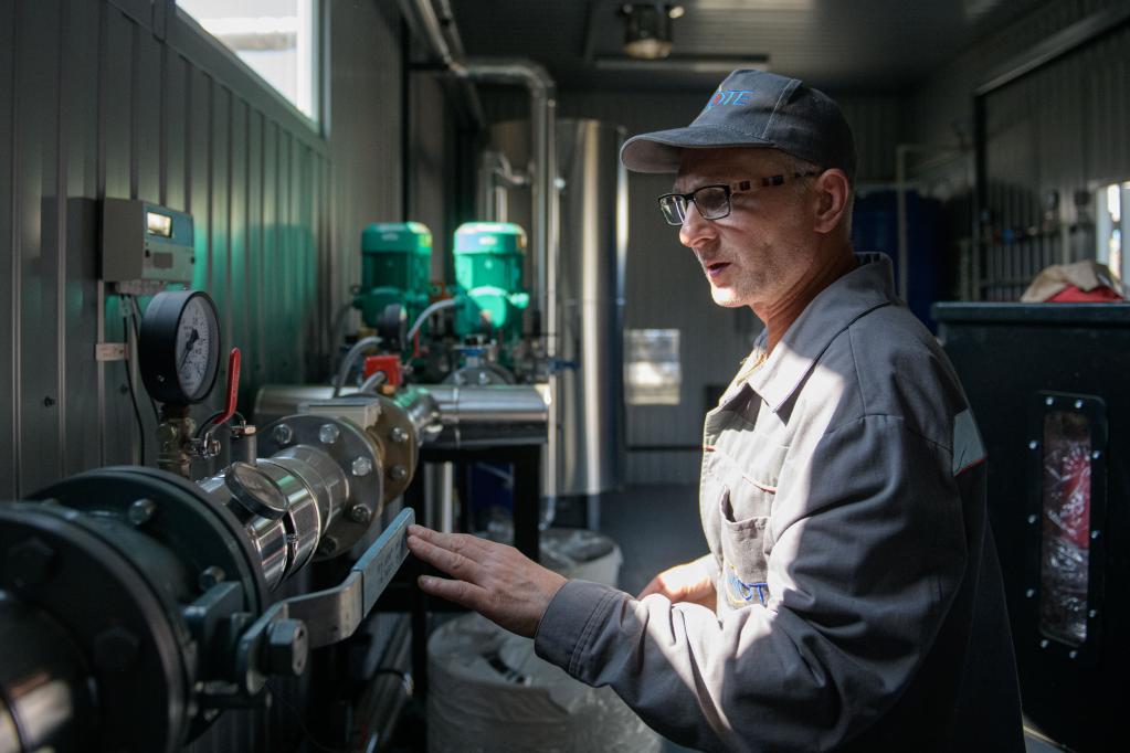 A staff member of Mykolaivoblteploenergo examines the equipment inside one of the boiler houses