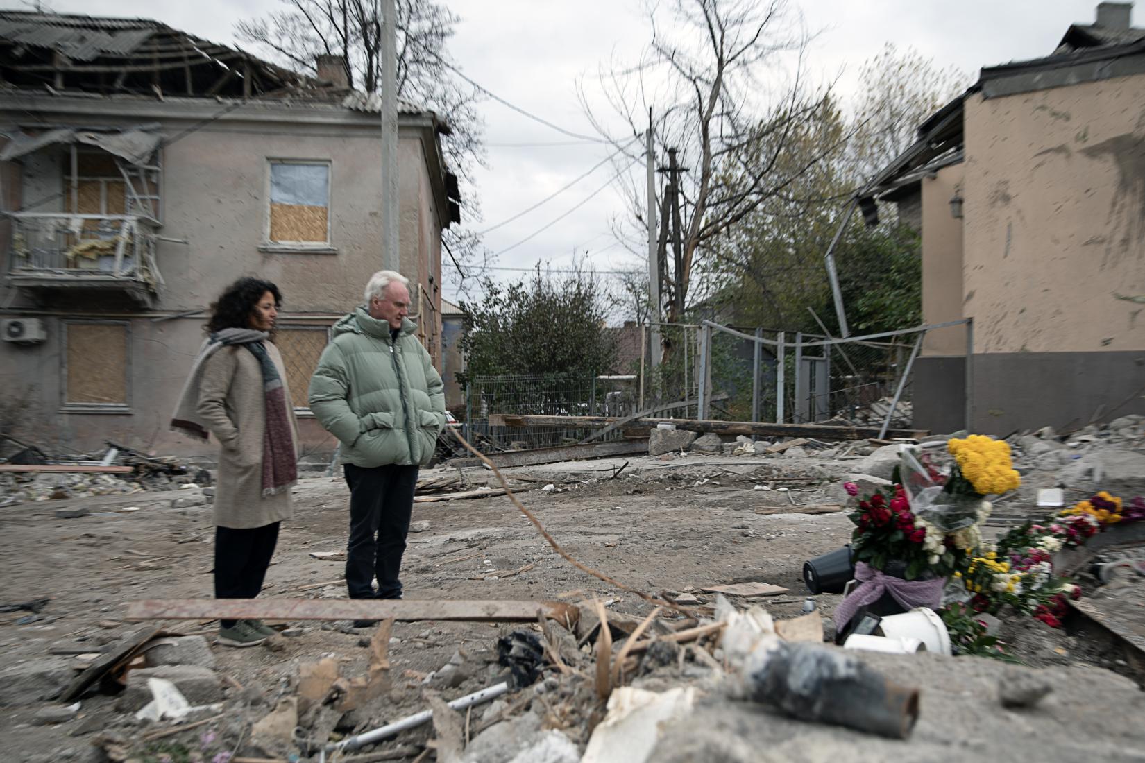 People standing in front if the damaged building 