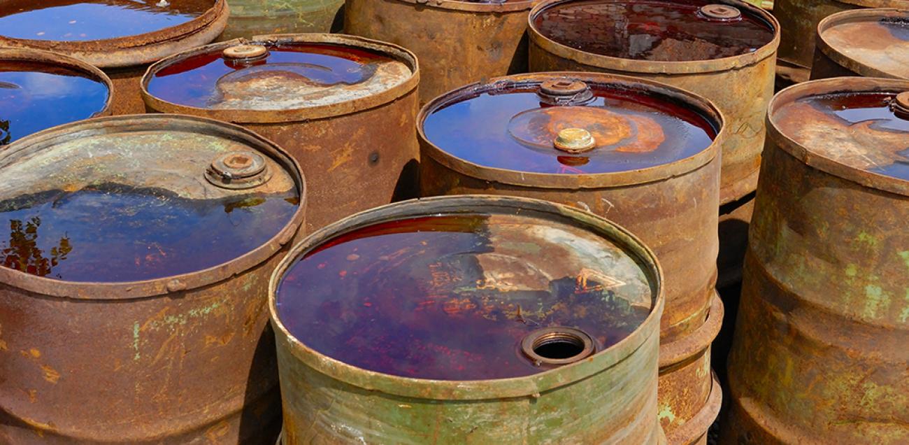 empty rusting toxic chemical barrels