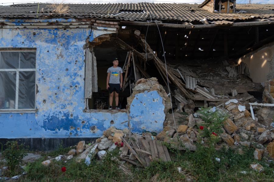 Picture: Sashko, 15, stands near his destroyed school in the village of Novohryhorivka in southern Ukraine. 